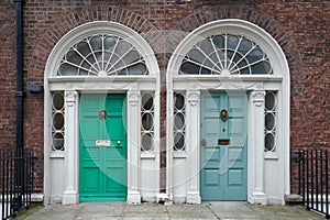 A pair of neighboring Georgian style front doors photo