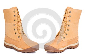 A pair of new yellow military leather dr. Marten Timberland boots shoes. Two isolated photo