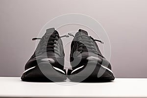 Pair of new unbranded black sport running shoes, sneakers or trainers isolated on white background