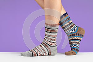 A pair of new, warm socks on women`s legs, close-up.