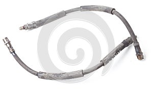 Pair of old brake hoses on white background in photo studio - a high-pressure hose with fluid and metal nozzles for replacement