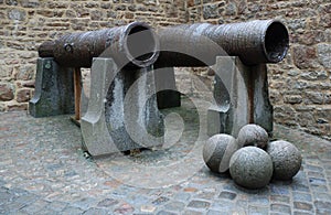 Pair of old cannons with stone balls, close-up