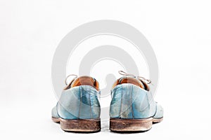 Pair of old leather blue discarded boots with laces