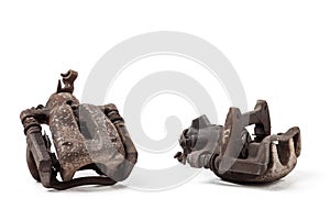A pair of old metal brake calipers covered with rust on a white background in a photography studio Spare parts for replacement in