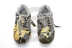 Pair of old paint covered training shoes photo