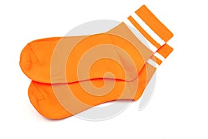 Pair of orange socks isolated on white background