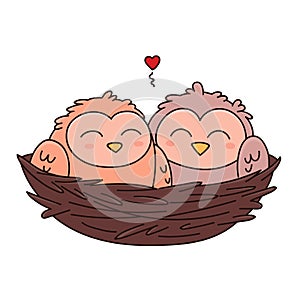 A pair of owls in love is sitting in a nest woven from twigs.