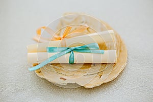 Pair of paper roll parchments tied with ribbon on a seashell, love messages