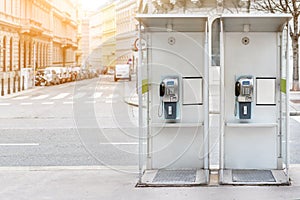 Pair of payphone booth in Vienna center street. Two modern public phones on european city street. copyspace