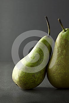 A pair of pears on a dark background