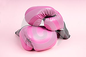 Pair of pink boxing gloves on pink background