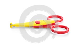 Pair of plastic scissors on white