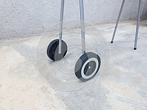 A pair of plastic wheels from a mobile grill