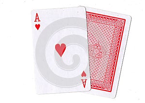 A pair of playing cards with the ace of hearts revealed.