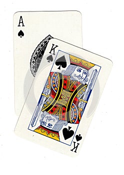 A pair of playing cards showing an ace and a king of spades.