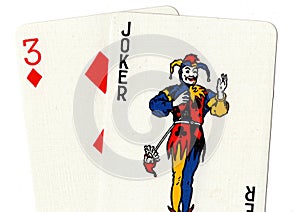 Pair of playing cards showing a joker and a three.