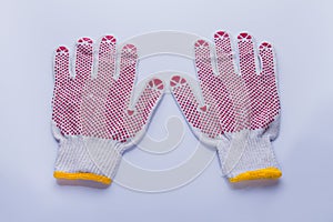 Pair of protective working cotton gloves with red rubber dots.