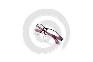 Pair of red and black folded spectacles isolated on white background
