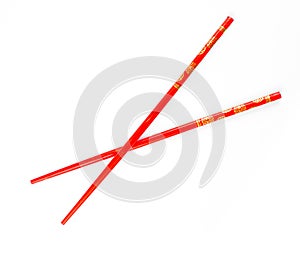 Pair of red chopsticks isolated photo