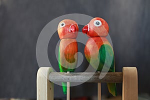 Pair of red-green lovebird parrots wooden toy