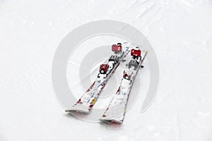 Pair of red skis on white snow. Austria