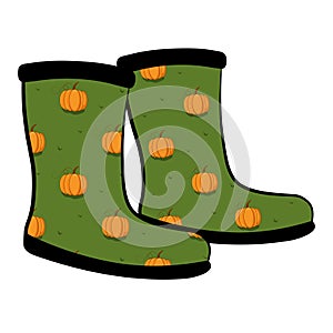 Pair of rubber boot in pumpkin pattern on green background