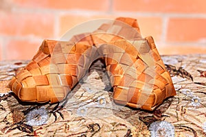 Pair of Russian bast shoes on patterned cloth