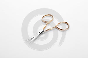 Pair of sharp sewing scissors on white