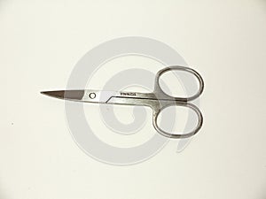 pair of silver closed nail scissors sharp white background studio