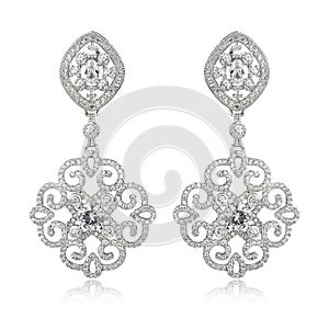 Pair of silver diamond earrings isolated on white