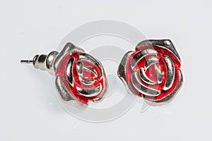 Pair of silver earrings in the shape of a rose with red details