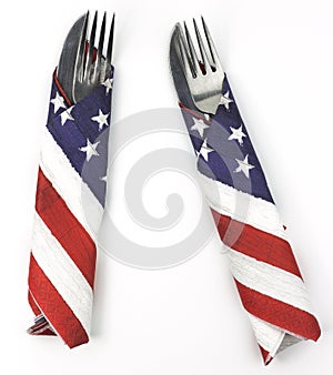 Pair of silverware wrapped in American flag napkins