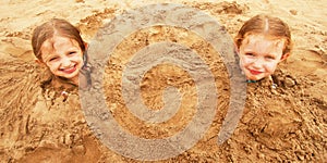 A Pair of Sisters Buried in the Sand