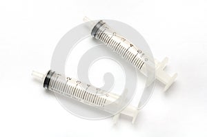 A pair of six millilitre syringes