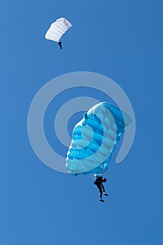 Pair of skydivers with on a blue sky background