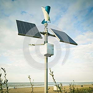 Pair of solar panels on a pole. Ecological energy. Cloudy sky.