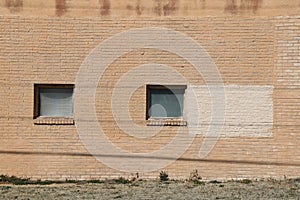 Square vintage windows facade brown brick wall warehouse building