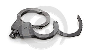 Pair of steel metal handcuffs isolated on white background