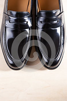 Pair of Stylish Expensive Modern Leather Black Penny Loafers Shoes.Closeup Shot