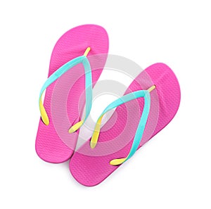 Pair of stylish pink flip flops isolated on white. Beach object