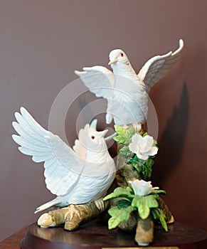 a pair of swans, a statue of lovers, a white statue
