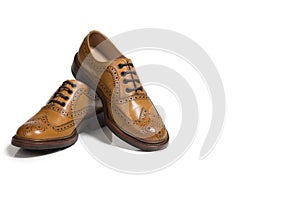 Pair of Tanned Brogue Derby Shoes Made of Calf Leather with Rubber Sole Isolated Over Pure White Background