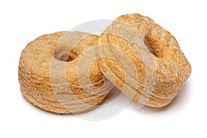 Pair of tasty sweet cinnamon Cronuts isolated on white background