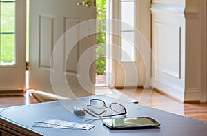 Pair of theater tickets on table with front door