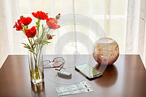 Pair of theater tickets on table with window