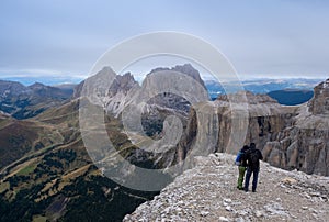 Pair of tourist looking on Italian Dolomite from Sass Pordoi Terrazza Delle Dolomiti