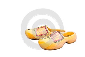 Pair of traditional Dutch yellow concrete shoes isolated on  white background. Holland clog shoes photo