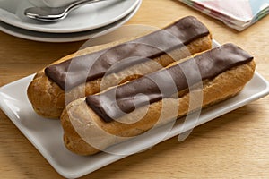 Pair of traditional French eclair on a plate