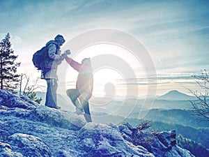 Pair of travelers on peak trail. Two photographers, a man and woman