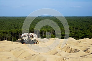 Pair of trekking shoes on the sand